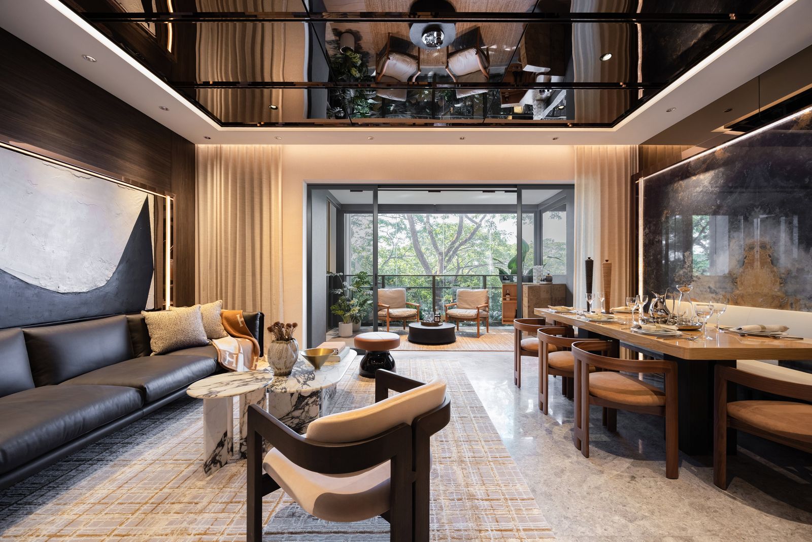Living and dining area with a balcony facing mature trees